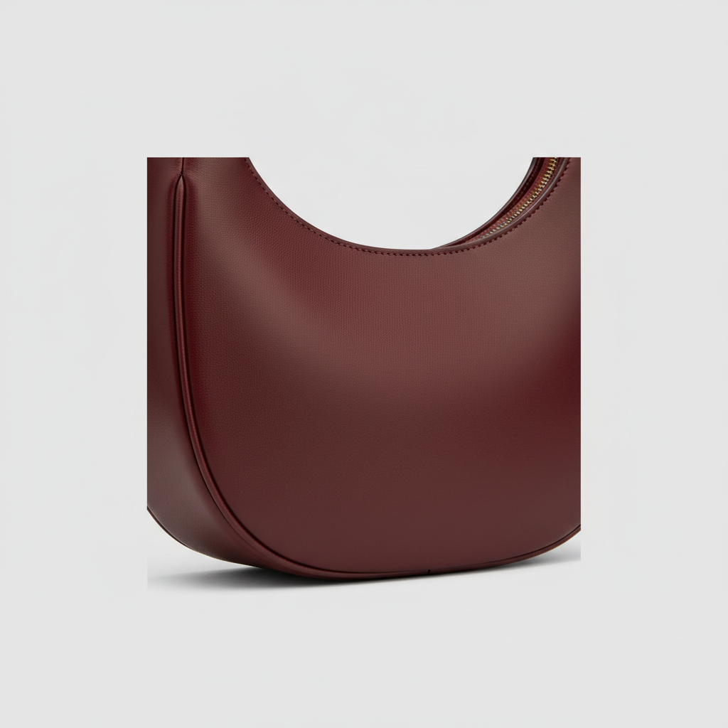Graceful Gather crescent shoulder bag in Ruby Wine – leather detail close-up